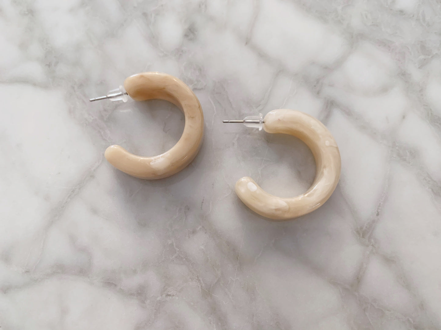 Marble stone half hoop pierces.